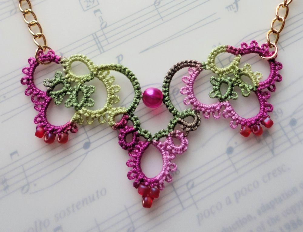crochet jewelry pink crochet necklace laying on music book oktypof
