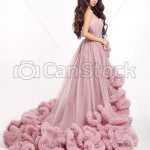 Beautiful woman in luxury lush pink dress. fashion lady brunette .
