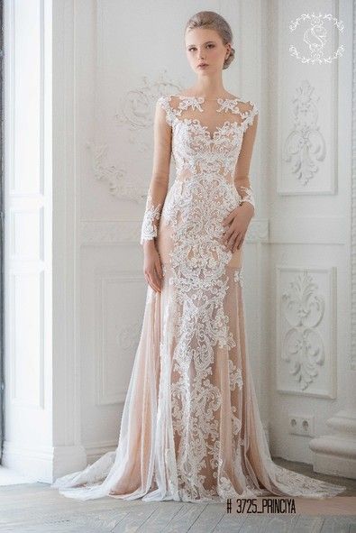 Wedding dress with illusion necklane and lace sleeves in champagne .