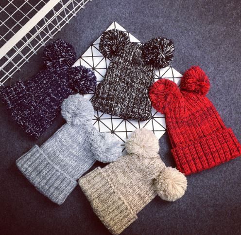 Keep warm and look cute with these pom-pom beanies. Twice the pom .
