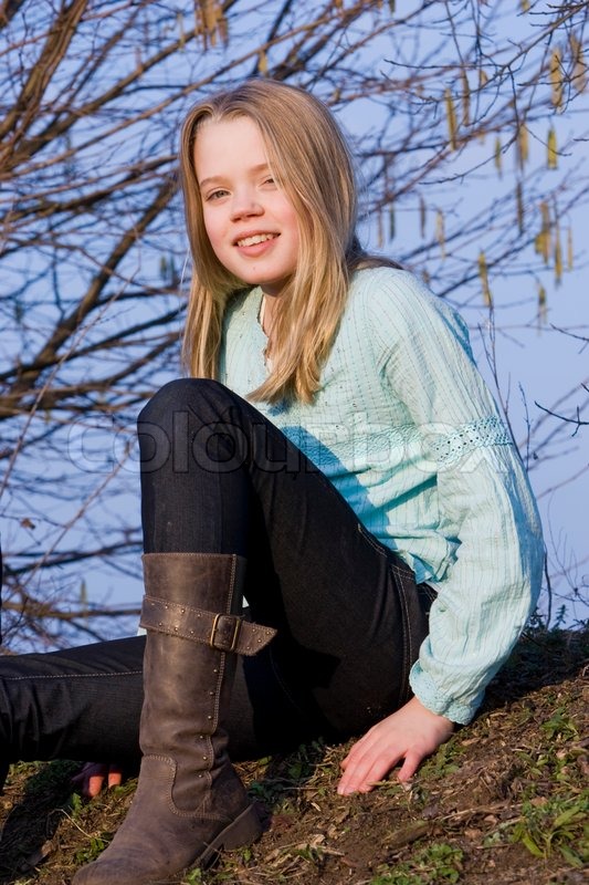 A smiling teenage girl with boots on | Stock image | Colourb