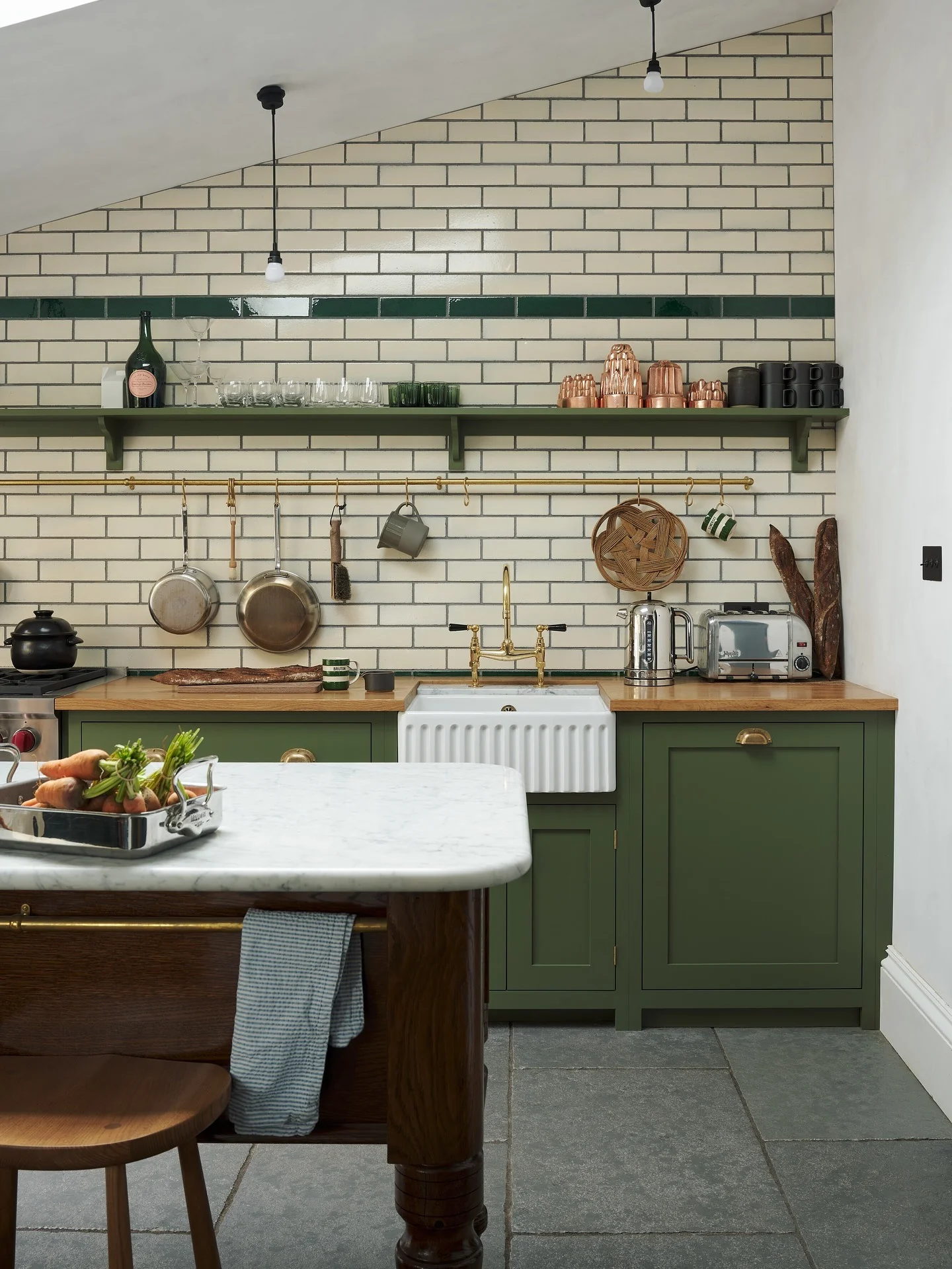 Timeless Grey Stone Flooring with Classic Green Cabinets