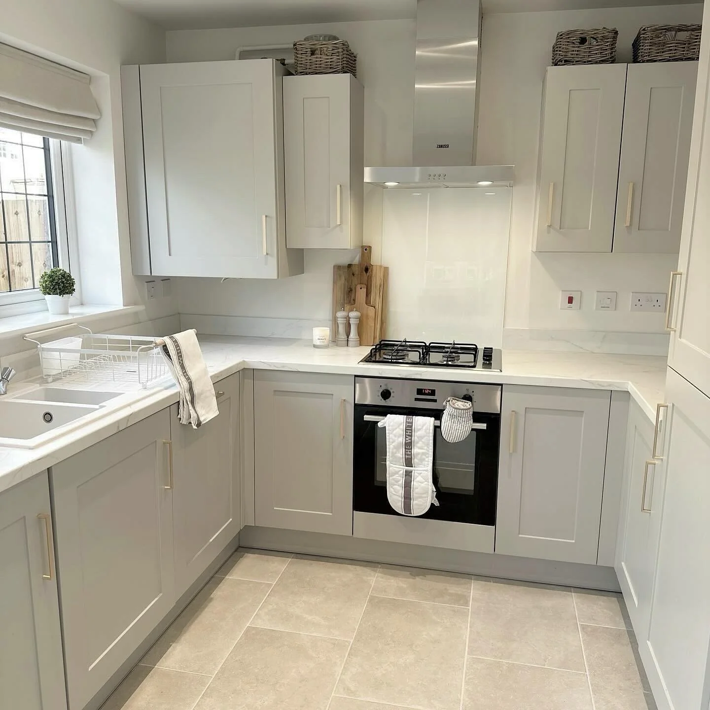 Warm Grey Tiles Paired with Soft Greige Cabinets