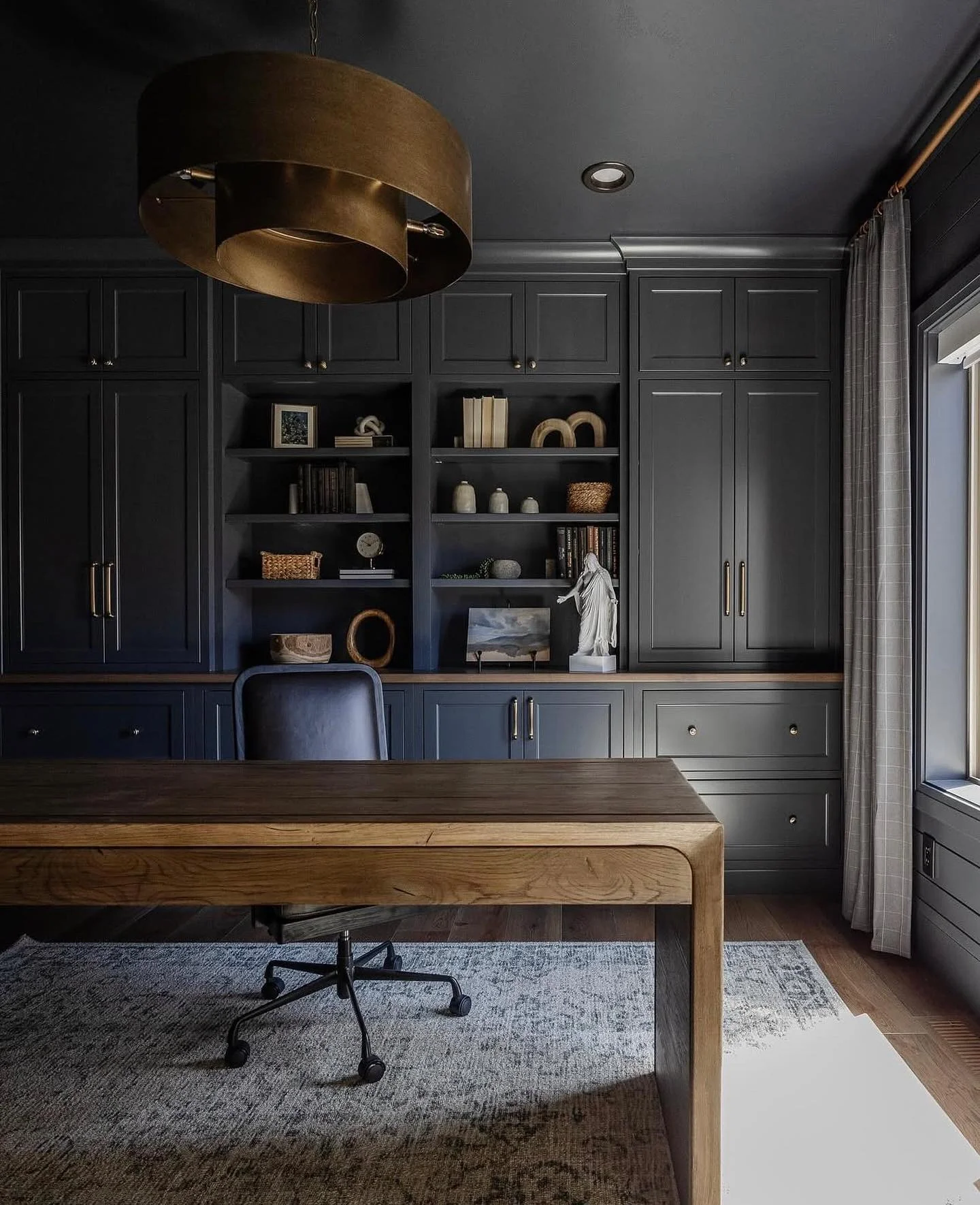 Dark Built-In Office with Charcoal Cabinetry and Brass Lighting