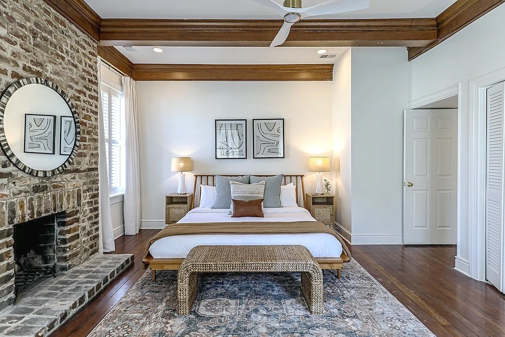 Inviting Bedroom with Brick Fireplace and Wood Details