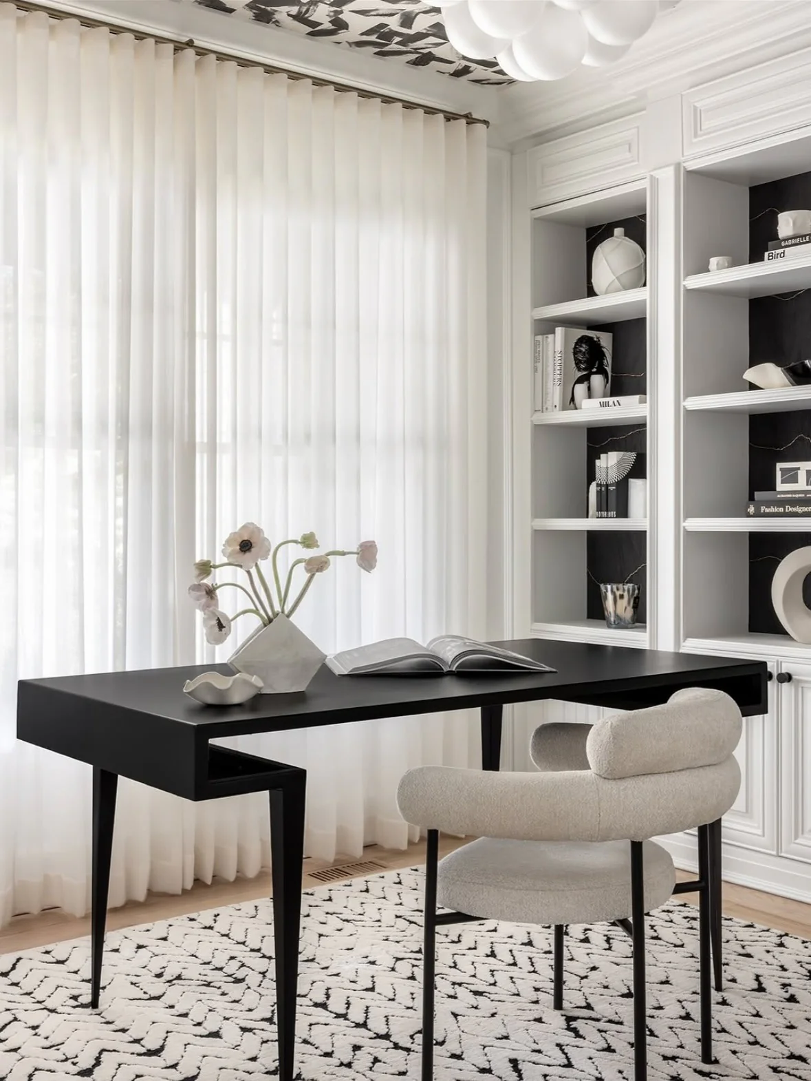 Monochrome Workspace Featuring a Sculptural Black Desk