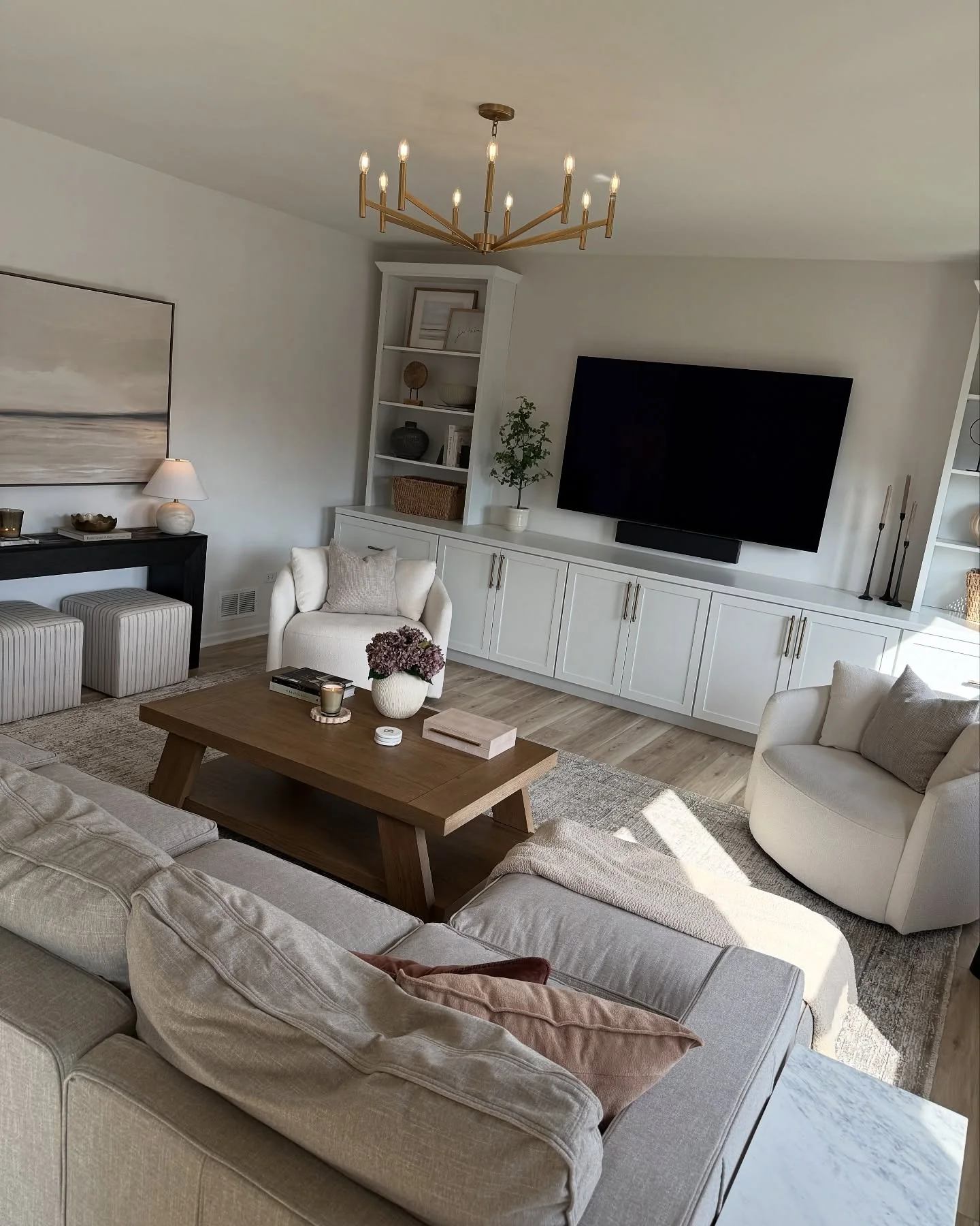 Modern Living Room with Brass Chandelier and Wood Table