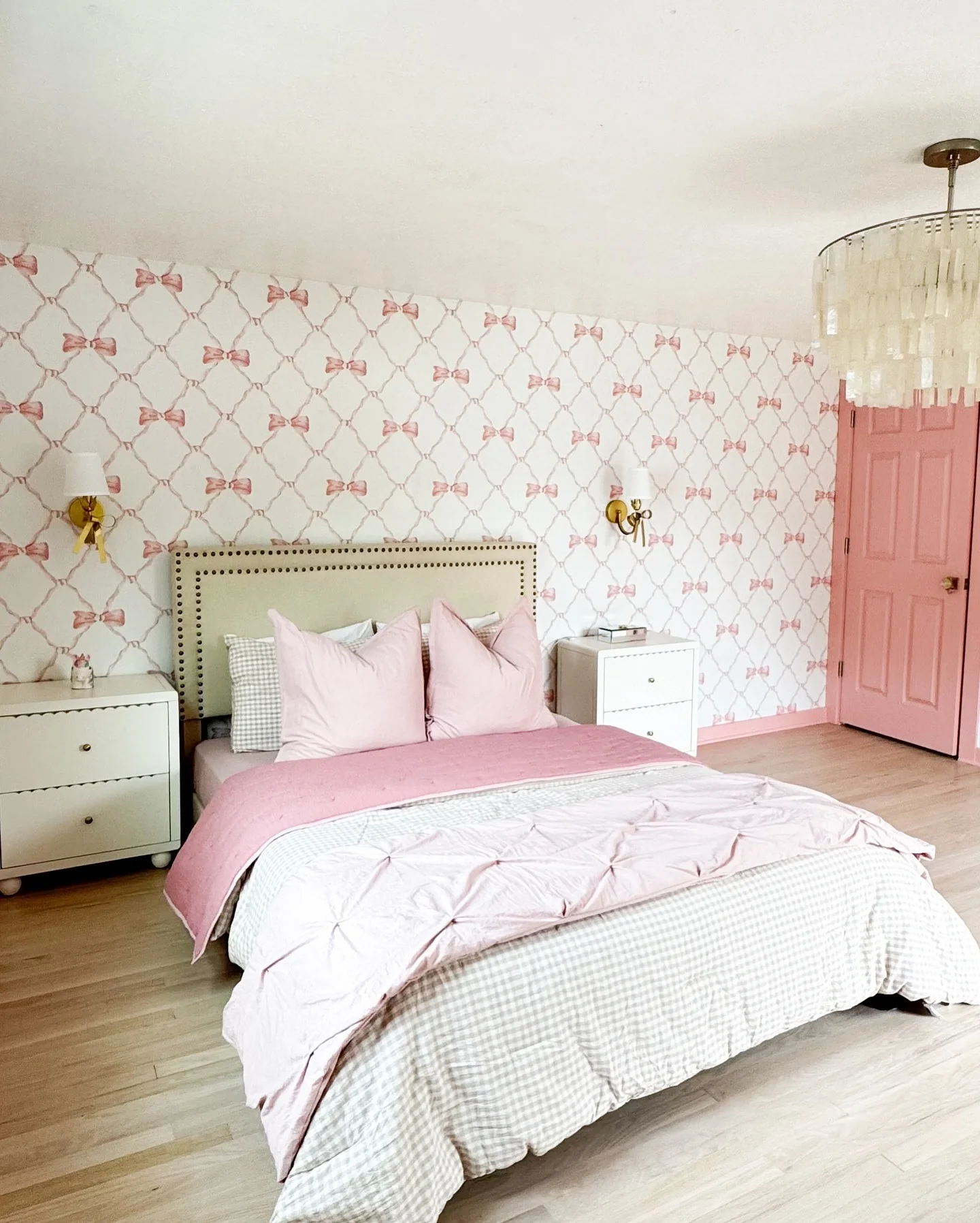 Playful Pink Layers with Bow Wallpaper Accents in Bedroom