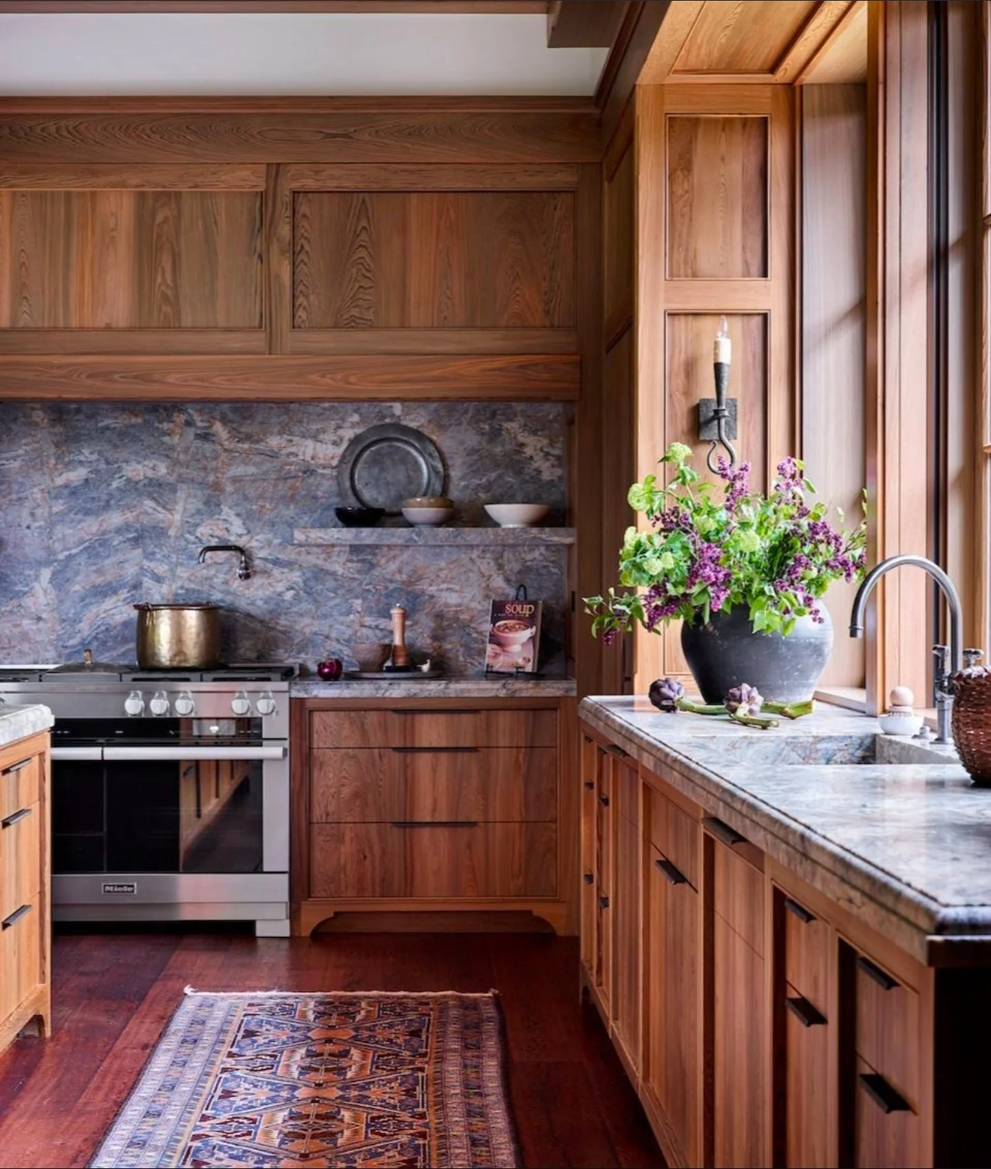 Rustic kitchen with walnut cabinets and stone backsplash