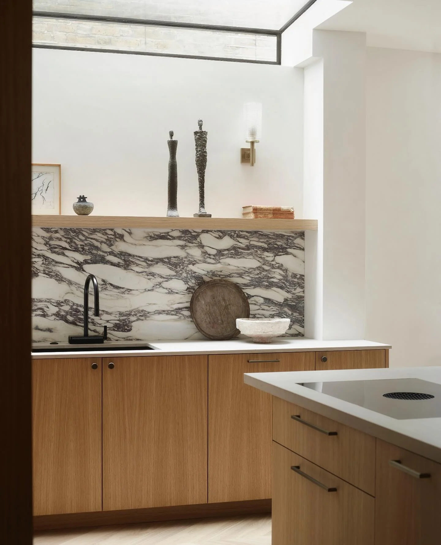Modern kitchen with marble and brown cabinets