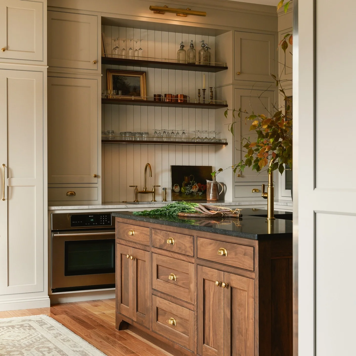 Kitchen with walnut island and cream cabinets