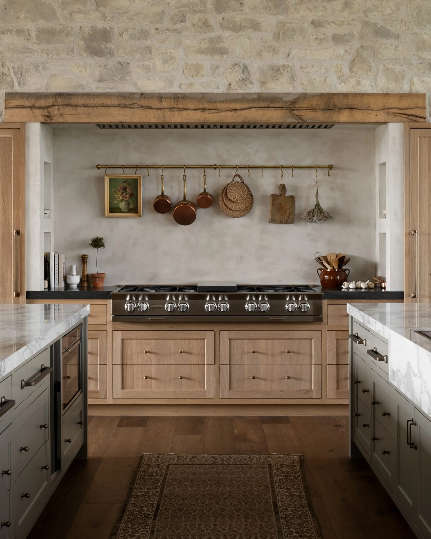 Rustic kitchen with stone wall and brown cabinets