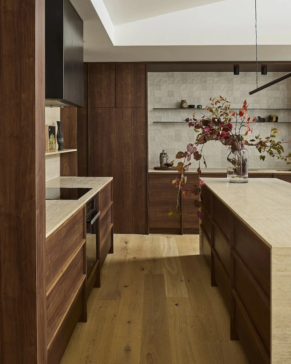 Modern kitchen with walnut cabinets and pale oak floors
