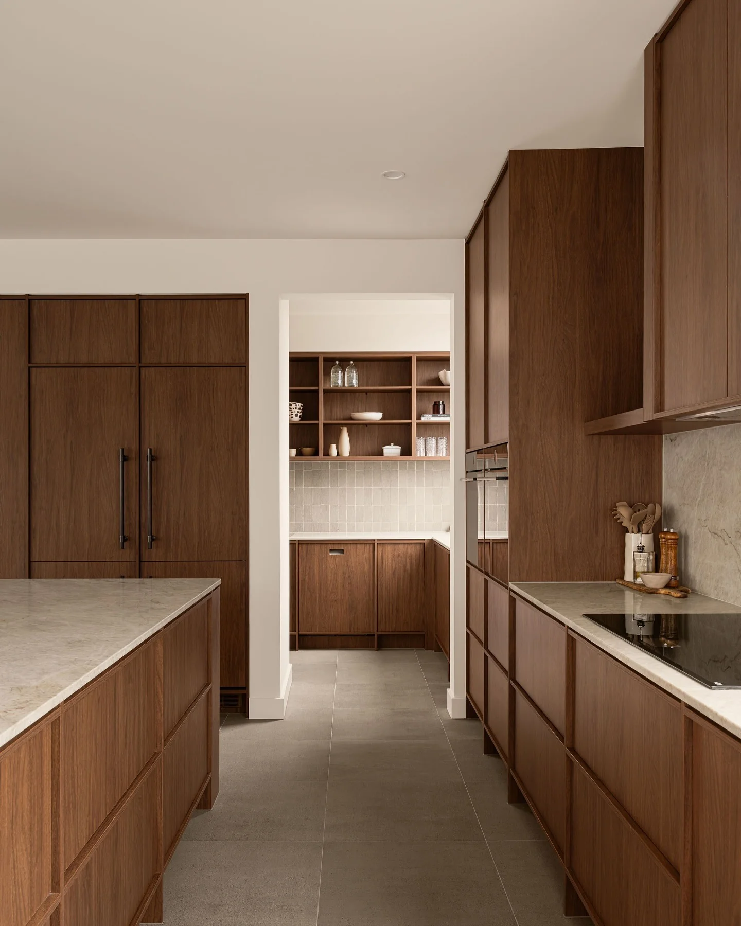 Minimalist kitchen with flat-panel walnut cabinets
