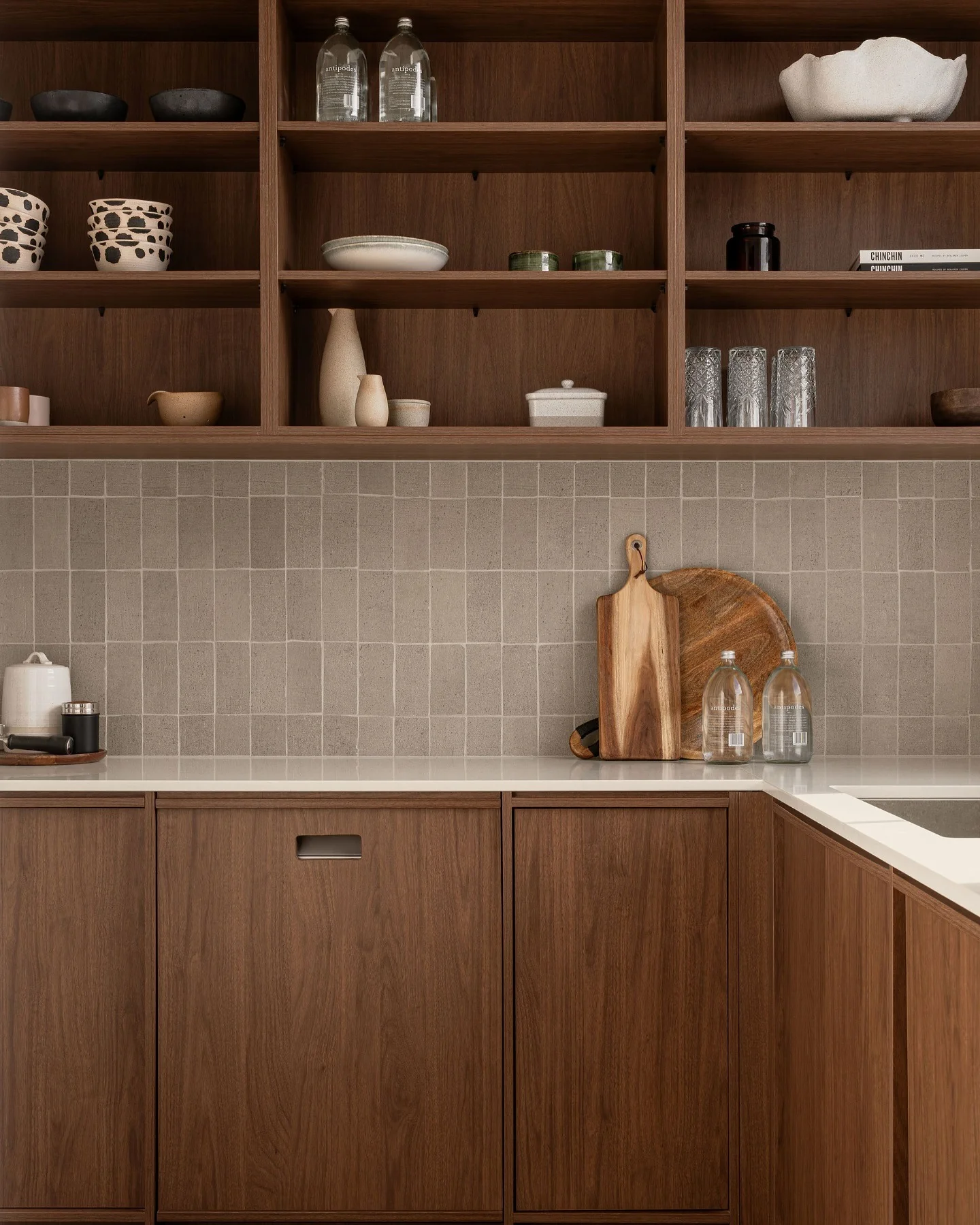 Pantry with grid tile and walnut open shelving