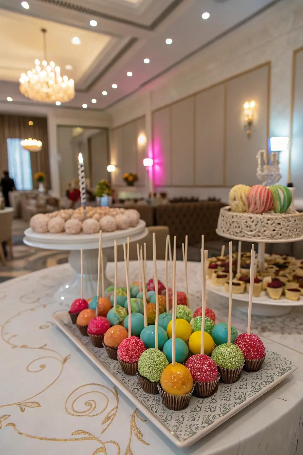 Cake lollipops add a playful and customizable element to sweet tables.