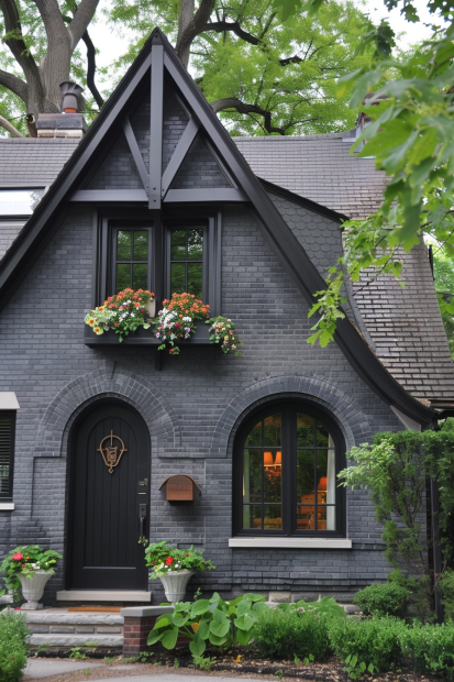 Gothic-inspired gray brick home with black trim
