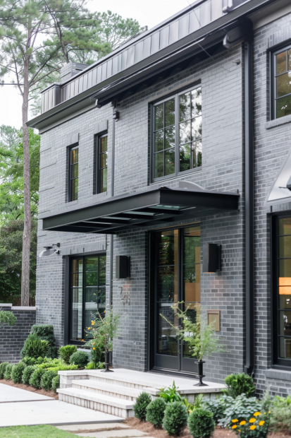 Modern gray brick home with black trim and canopy