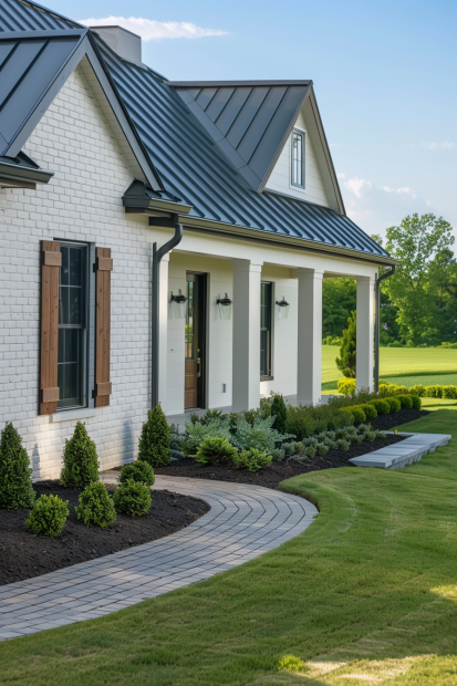 White brick farmhouse with wooden shutters and porch