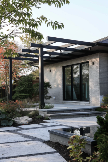 Gray brick house with black pergola