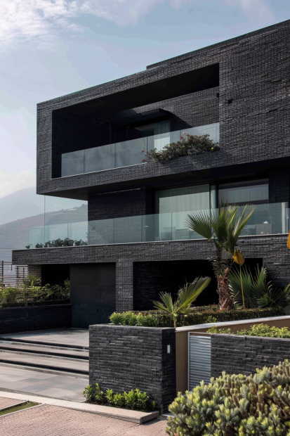 Black brick villa with geometric structure and glass balconies