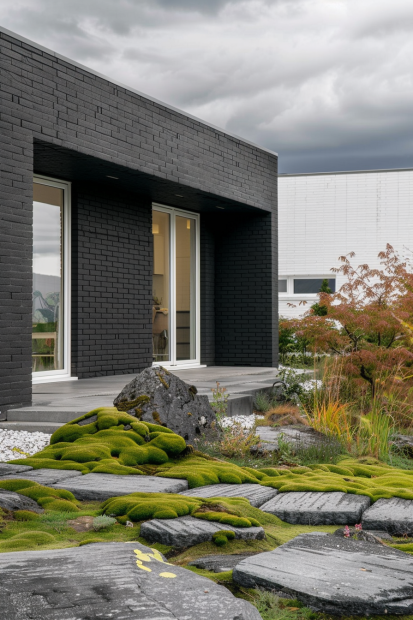 Minimalist black brick home with zen garden